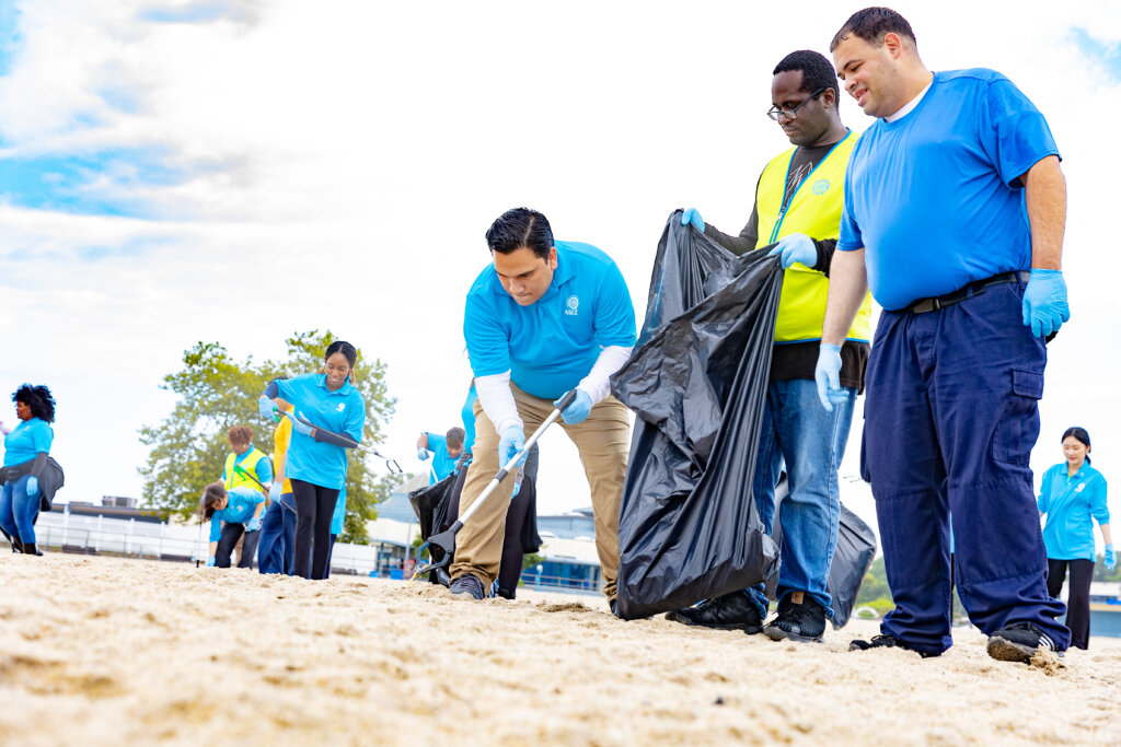 Volunteers gather trash on the beach