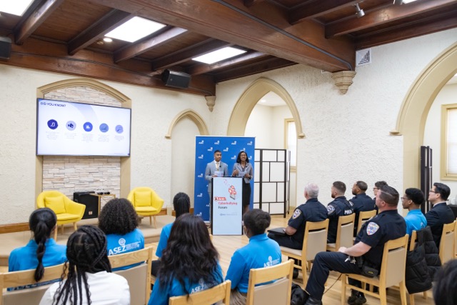 Hosts addressing forum participants 